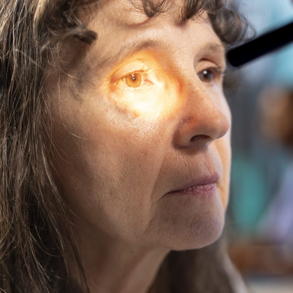 Optometrist examining eyesight with diagnostic tools for female patient. Experienced healthcare provider conducts vision test, consulting on eye care treatment and prescription options. Close up.